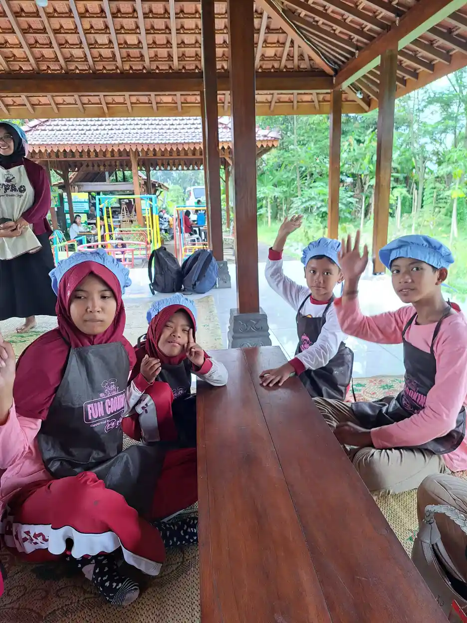 Anak-anak belajar memasak bersama dengan pendampingan dari guru, salah satu bentuk kegiatan terapi fungsional bagi ABK